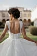 Abito da sposa Meteora di Sposae Atelier, schiena scoperta, tessuto scintillante, ambientazione elegante.