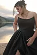 Abito da sera nero Maggie Sottero "Aspen Black" indossato da modella, sfondo paesaggio lacustre al tramonto.