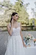 Abito da sposa Rebecca Romantica by Sposae, dettagli floreali, sfondo naturale, tavolo decorato.
