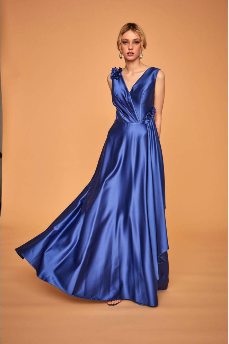 Abito da sera blu satinato LPA263 Linea Le Preziose, dettaglio floreale, sfondo beige.