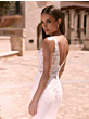 Abito da sposa NIREUS Bianco Evento, schiena scoperta in pizzo, ambientazione esterna elegante.