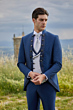 Abito elegante uomo Rocchini 44 blu, gilet e cravatta bianca, sfondo natura.