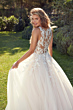 Abito da sposa Blake Eddy K con dettagli in pizzo floreale e schiena scoperta, ambientato in un giardino.