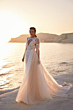 Abito da sposa ANWAR - DAMA al tramonto su una spiaggia, con dettagli in pizzo e tulle.