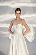 Abito da sposa L313 ARIAMO LIGHT, design elegante con fiocco posteriore, corpetto a cuore, sfondo neutro.