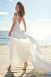 Abito da sposa MAEVE Maggie Sottero in spiaggia, design elegante con dettagli floreali e gonna fluente.