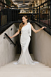 Abito da sposa bianco monospalla Buenos Aires di Sposae, indossato su una scalinata elegante.