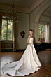 Abito da sposa elegante MILA - THE ROMANTICA COLLECTION in salone classico con lampadario e finestre.